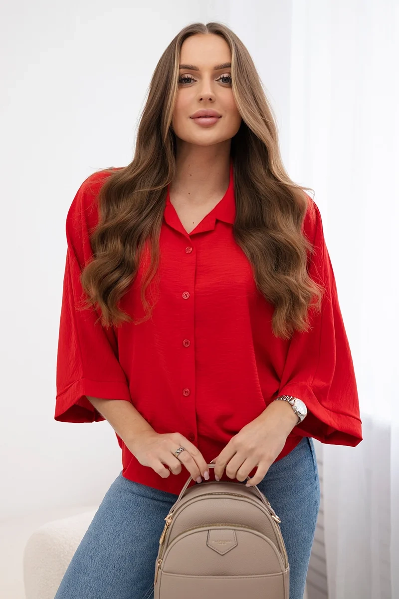 Oversized blouse with red button fastening