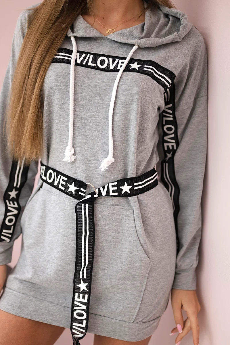 Dress decorated with a tape with gray inscriptions