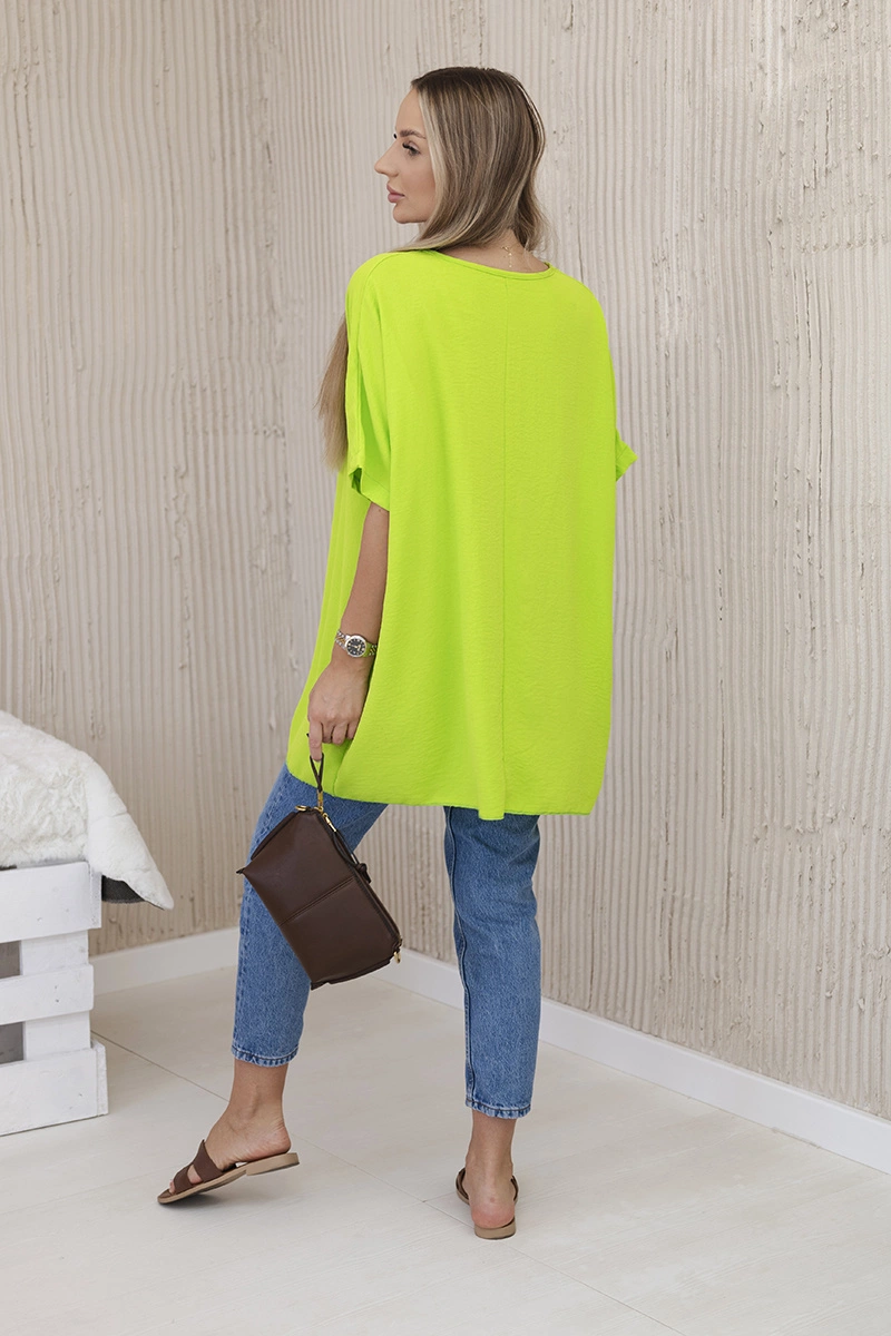 Oversized blouse with kiwi pendant