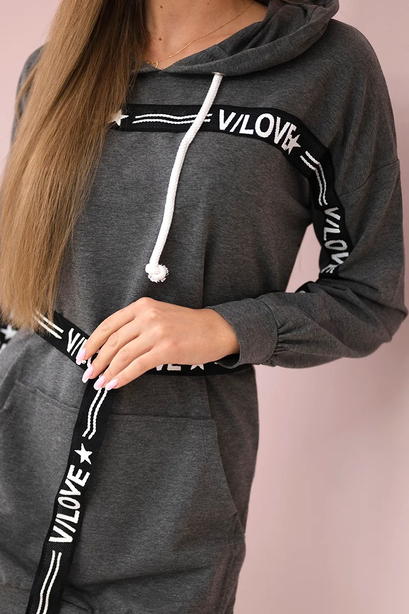 Dress decorated with a graphite slogan tape